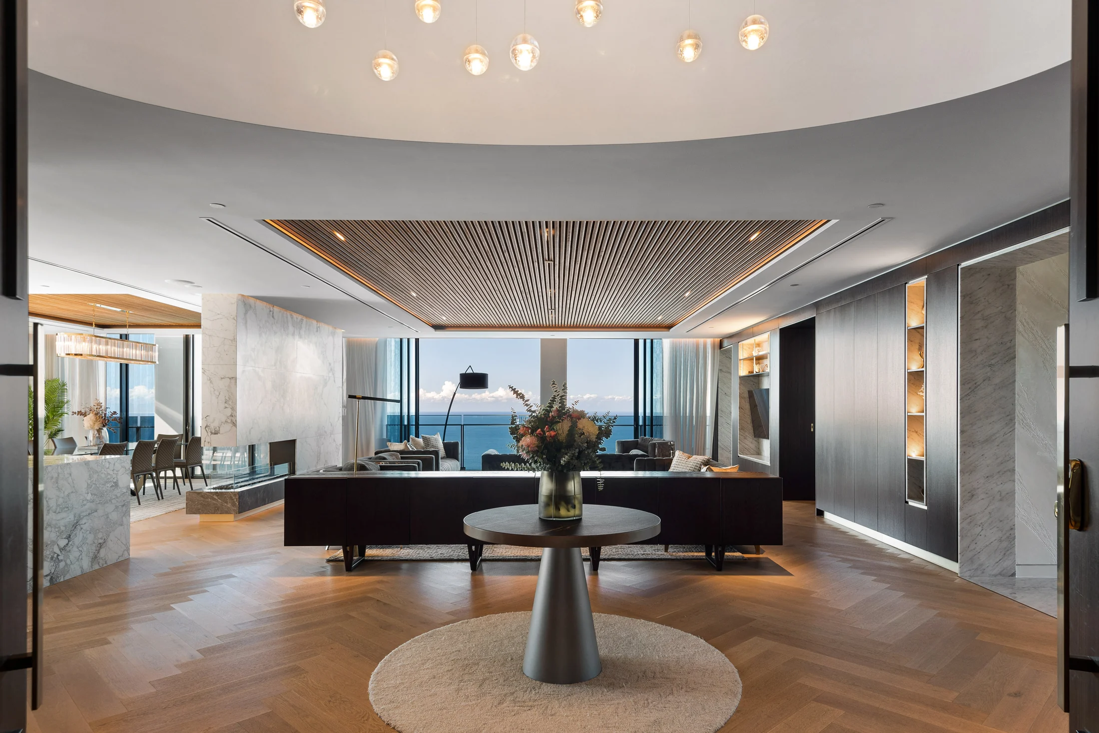 Expansive living room with an ocean outlook and double-height chandelier