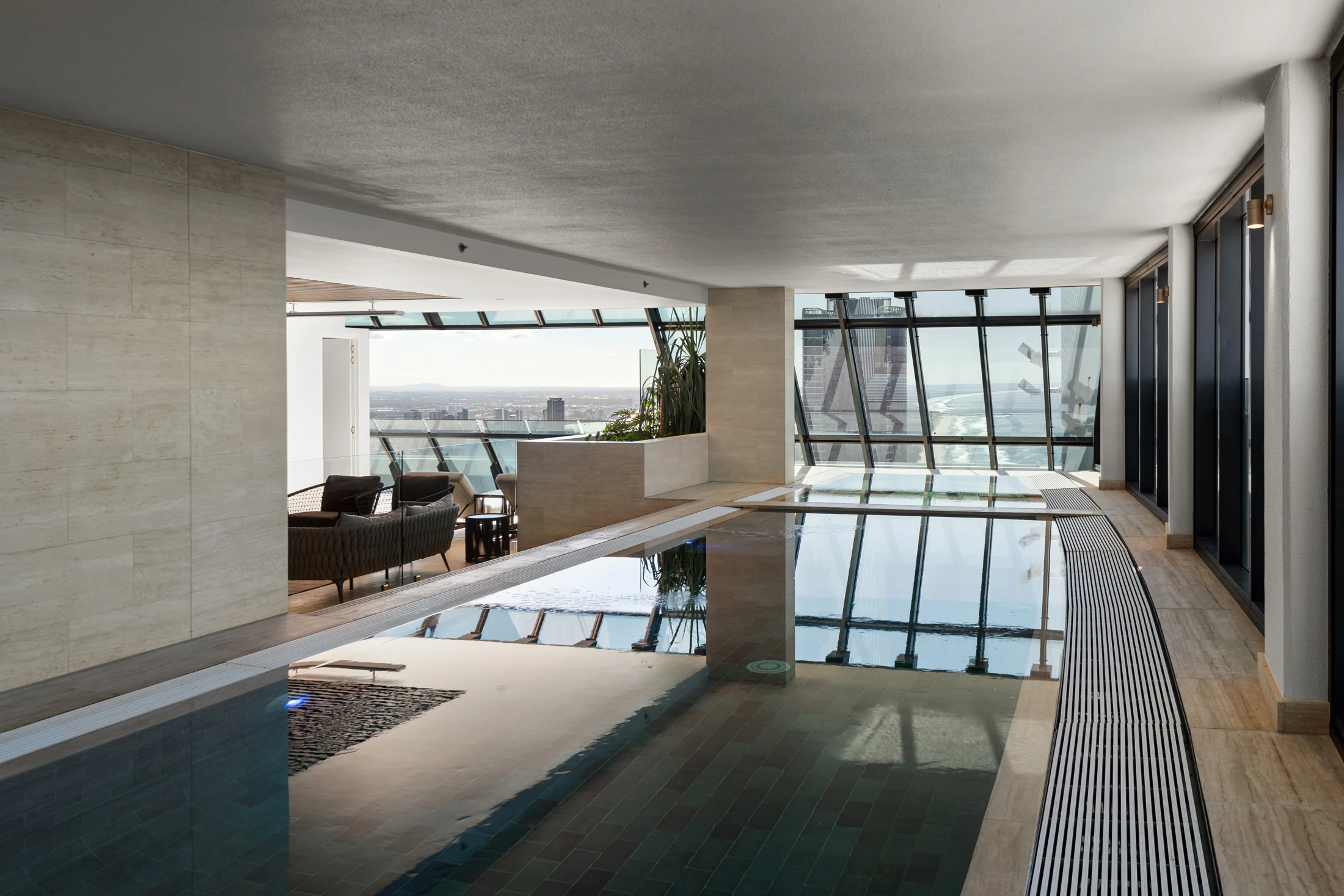 Private rooftop pool with an ocean-facing lounge in daylight
